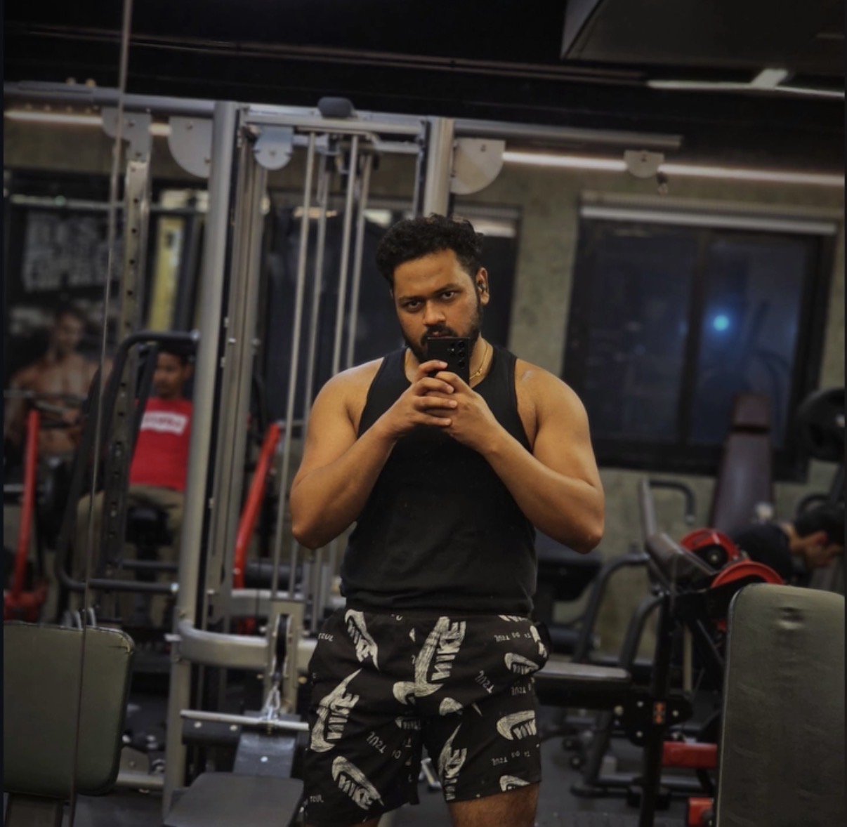 Aman taking a mirror photograph at the gym