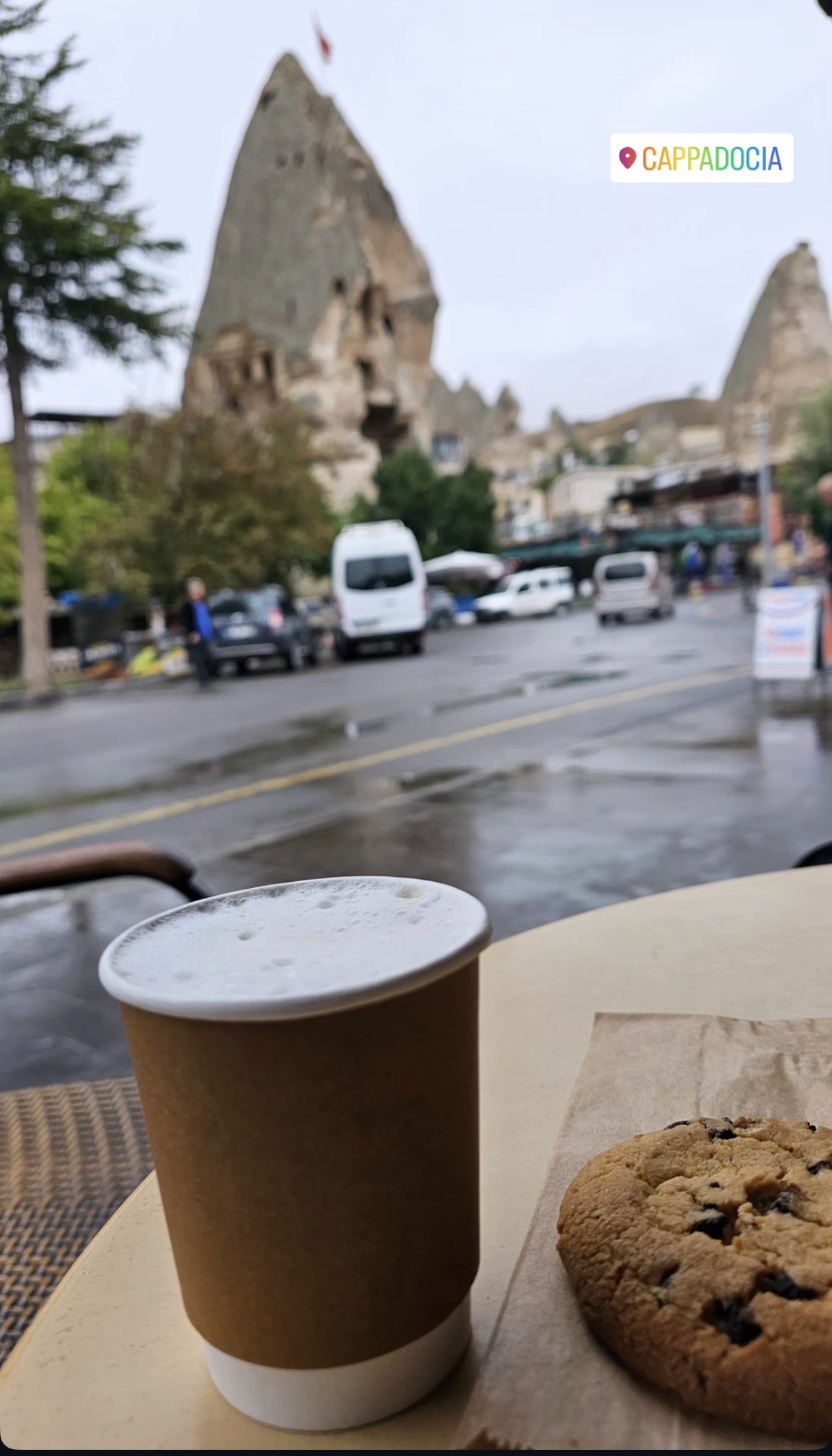 Coffee and a cookie beside a rainy street view